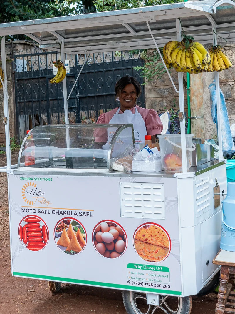 Cecilia Nduku standing at her Halisi Trolley